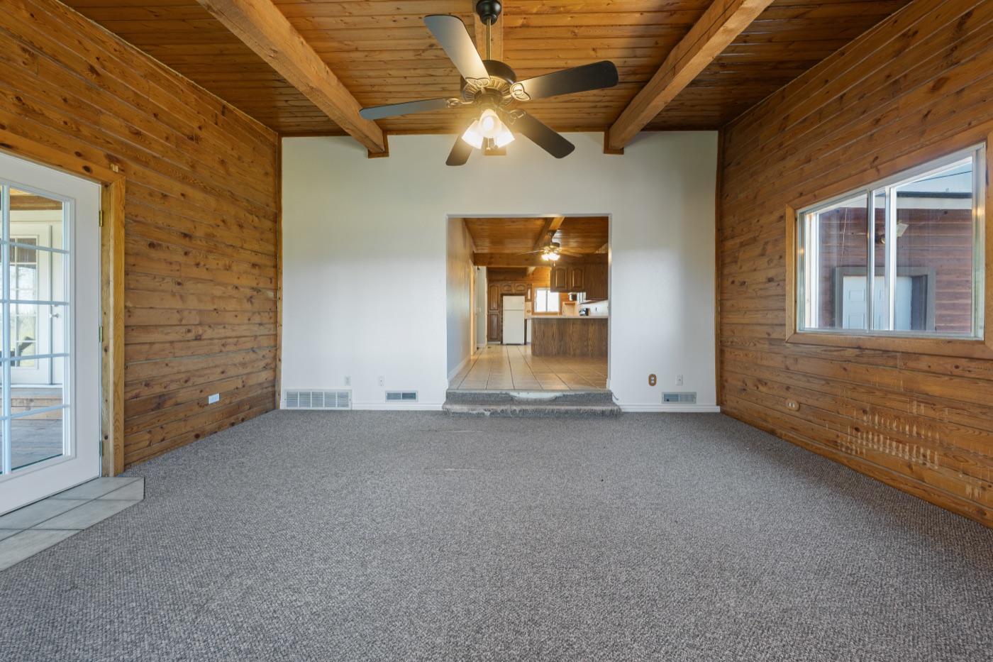 Family room and kitchen flow with vaulted wood ceiling