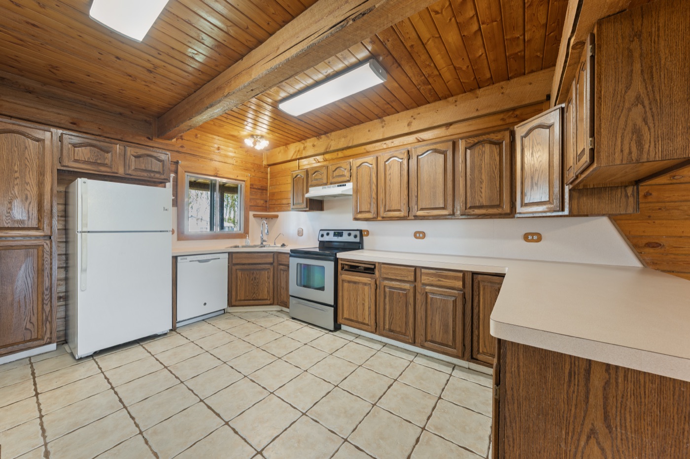 Kitchen alternate angle showing range and cabinetry