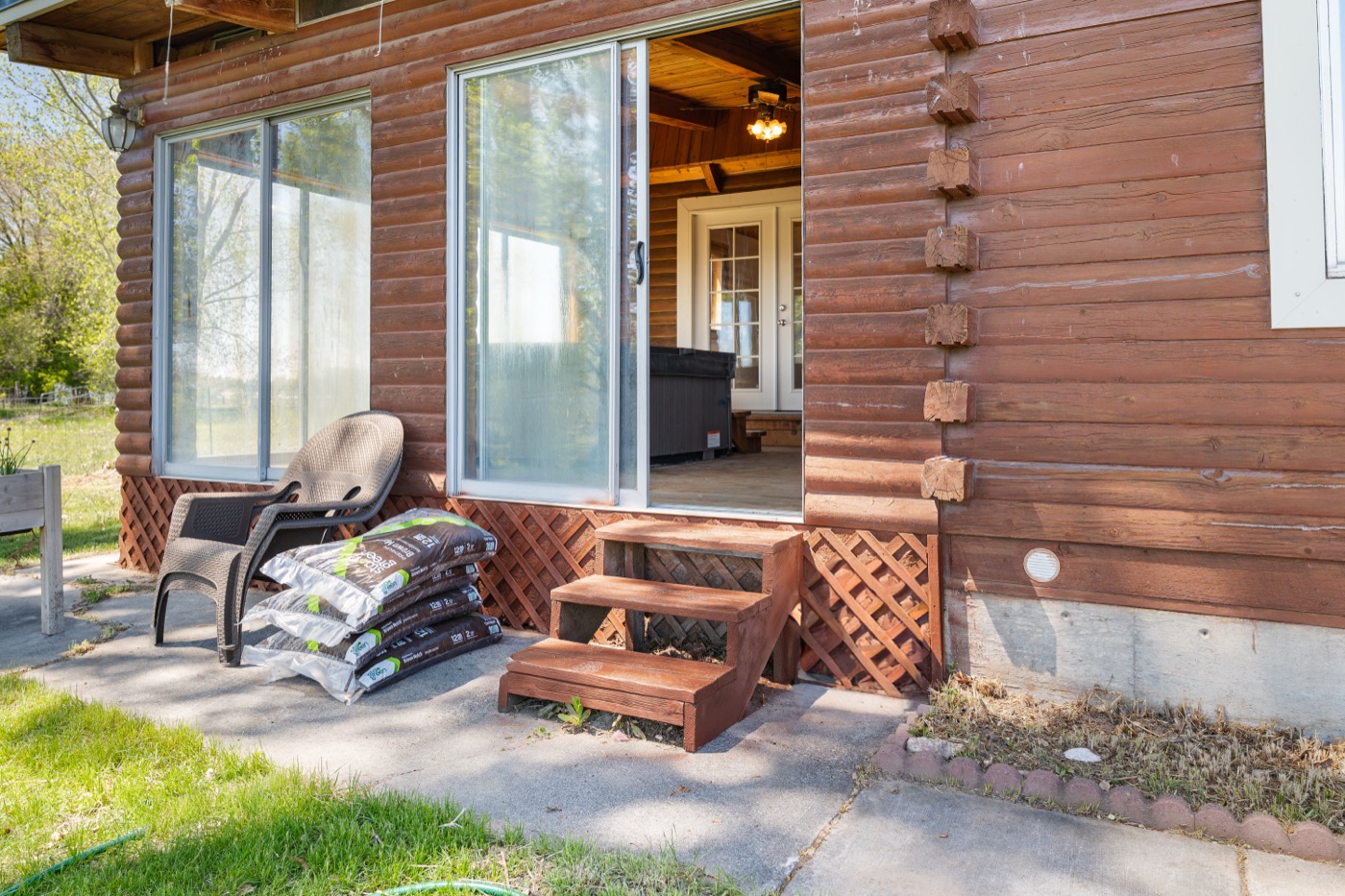 Sunroom from outside showing hot tub through windows